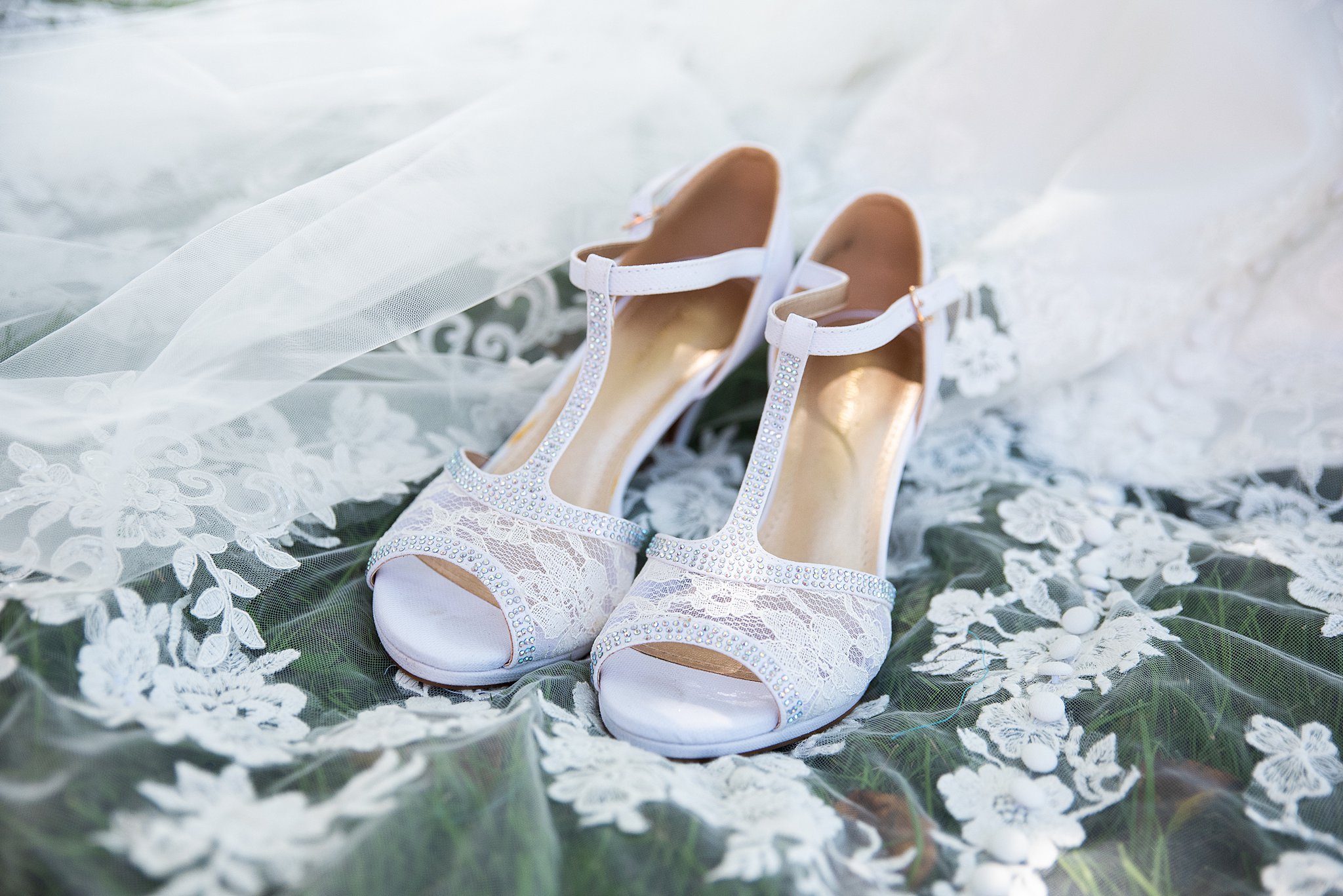 bridal shoes sitting on her veil at the Grand View Wedding Venue