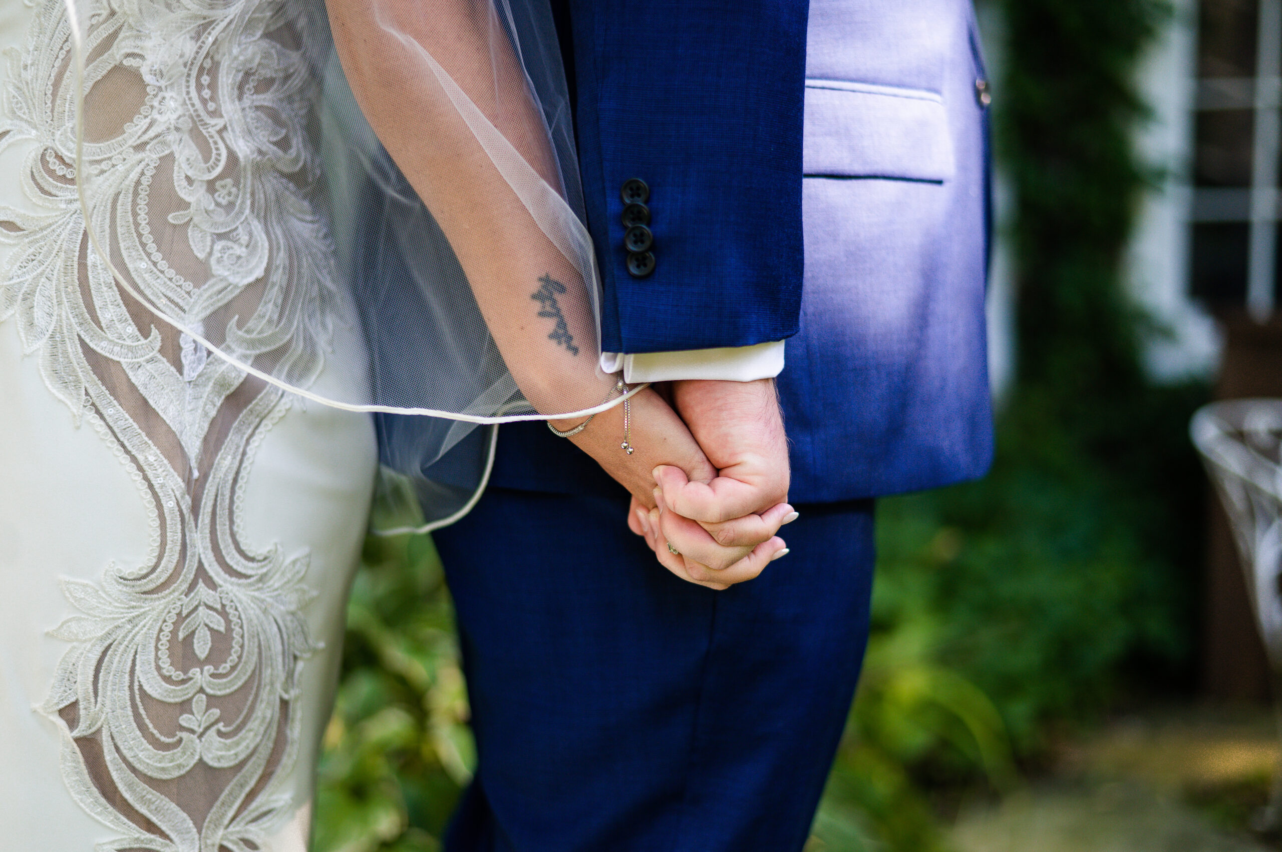 bride and groom holding hands down low at saphire estate wedding
