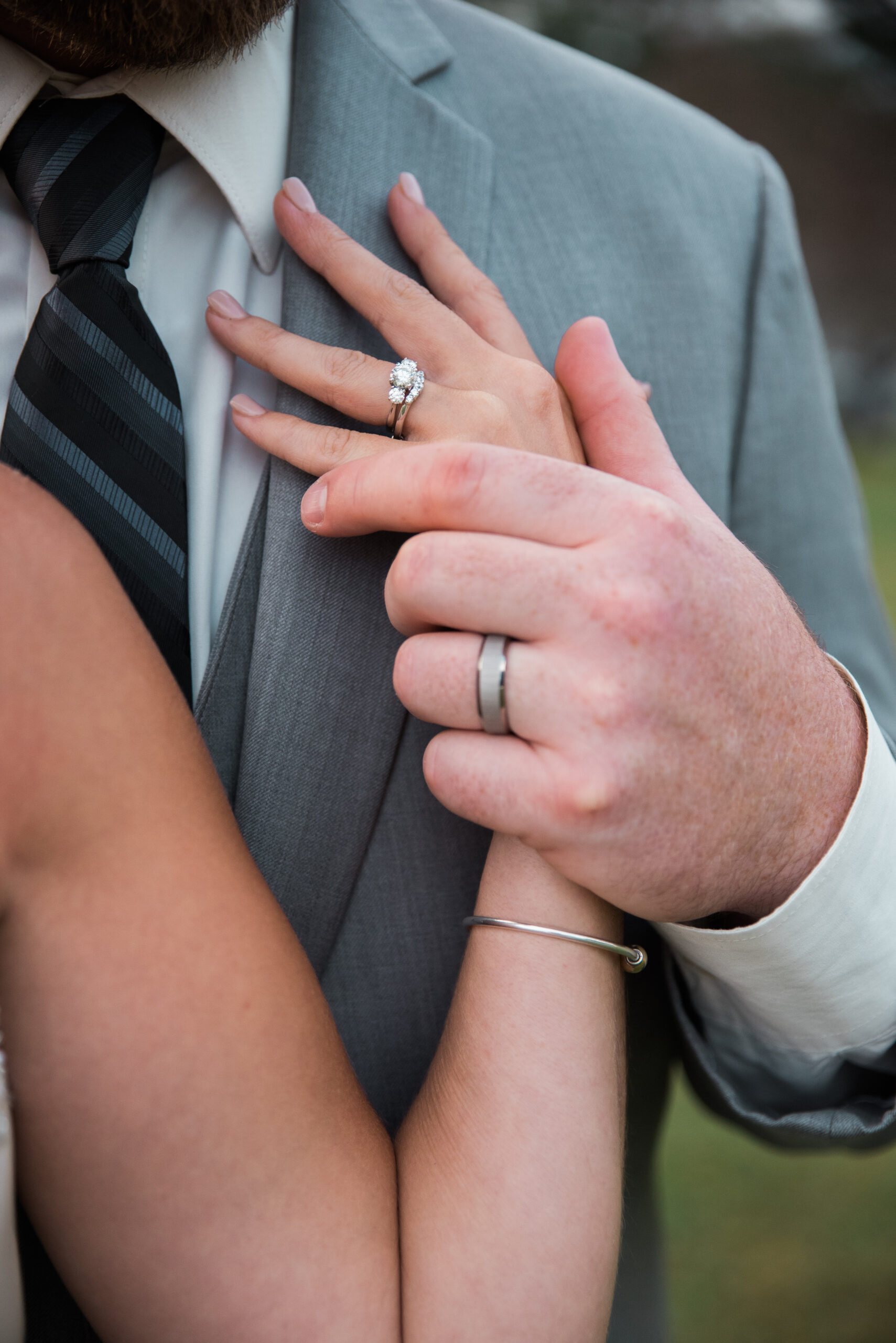 rings on the hands of a new bride and groom the conner center wedding