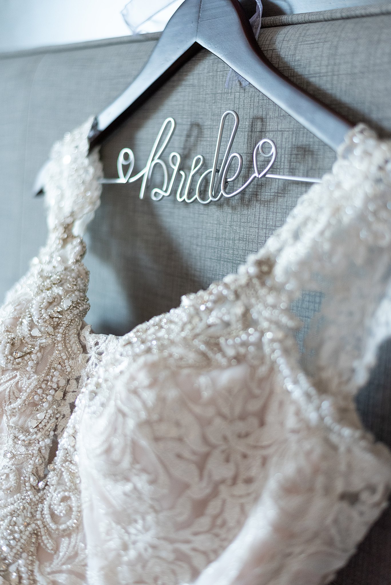 detail of a bride's dress and hanger